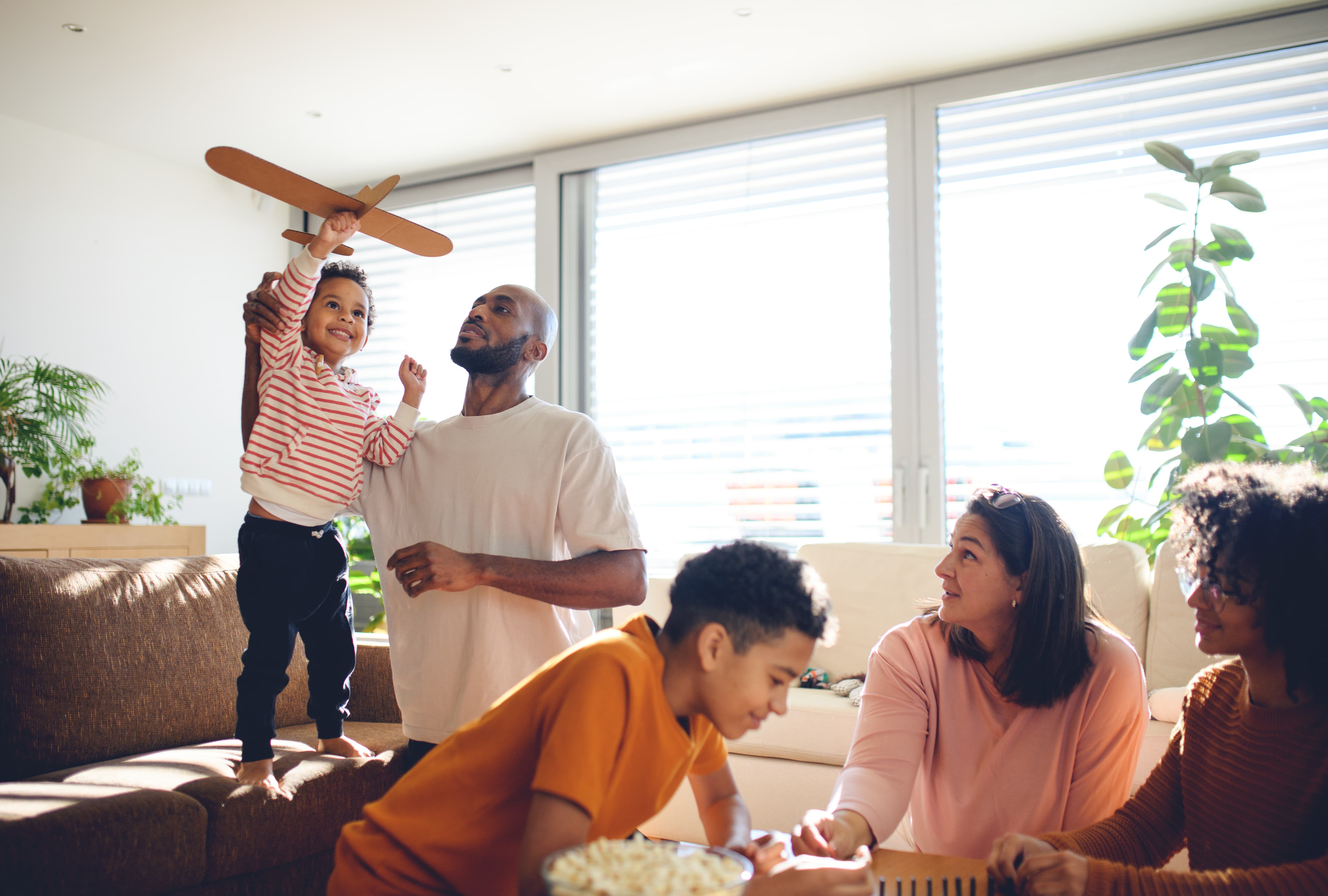Adults and children playing in a living room