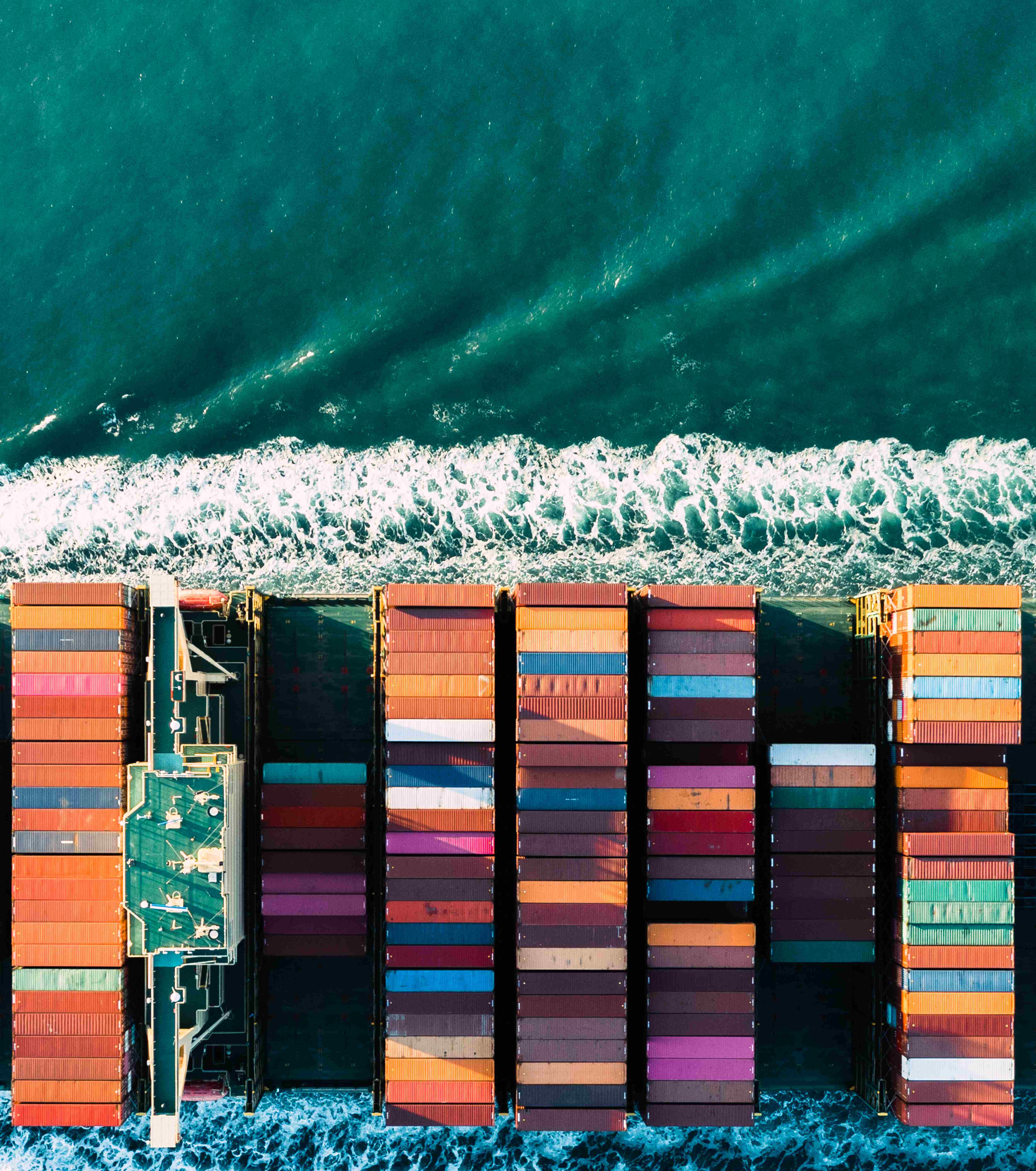 An aerial view of seabound colourful cargo containers