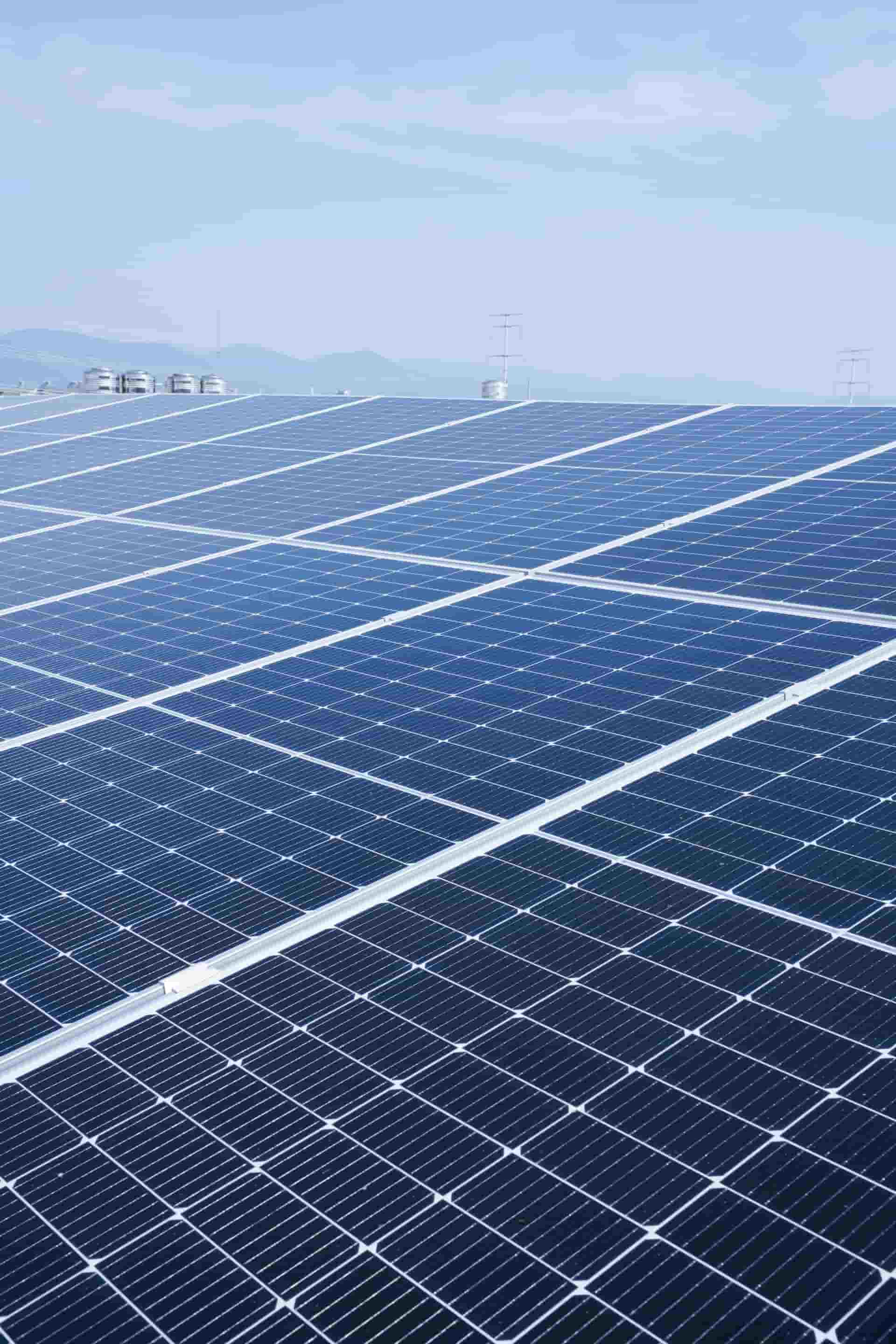 Many solar panels on a huge industrial facility roof