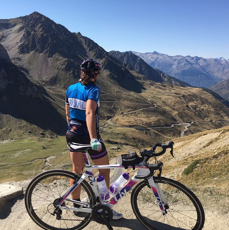 A Howden employee standing with a mountain bike at the top of a mountain path