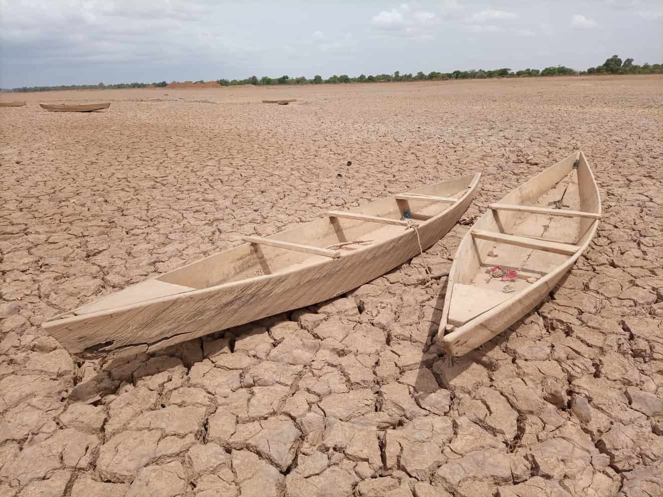 Two boats on an arid dried up lake